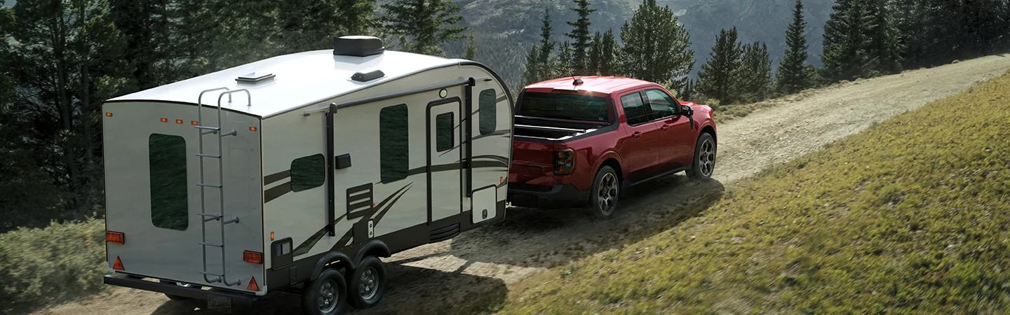 Red 2025 Ford Maverick towing a trailer