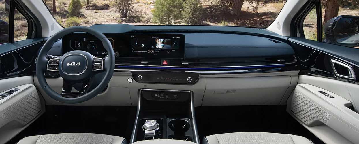 Interior view of the front seat and tech of a 2026 Kia Carnival