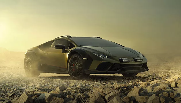 Black Lamborghini Huracán Sterrato driving on rugged rocky terrain