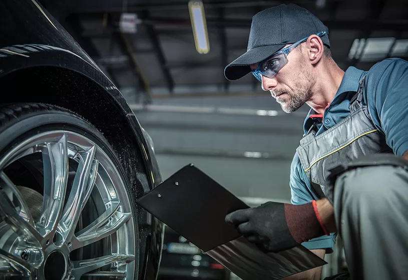 Lamborghini service technician inspecting a vehicle in the service center