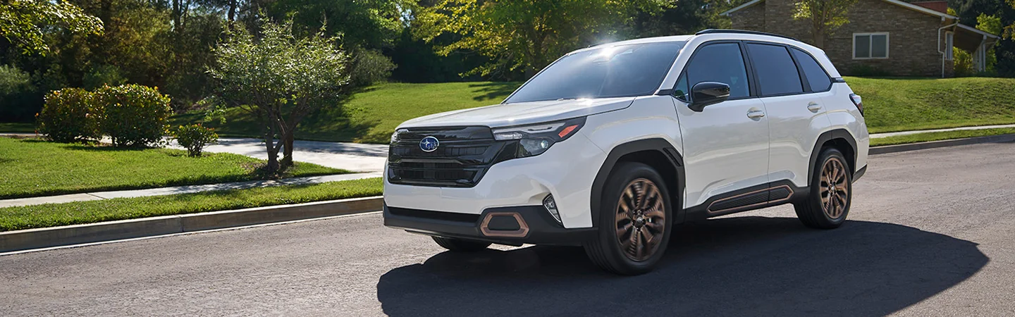 Front view of a parked 2025 Subaru Forester at a park with people in it it working in Nederland, TX