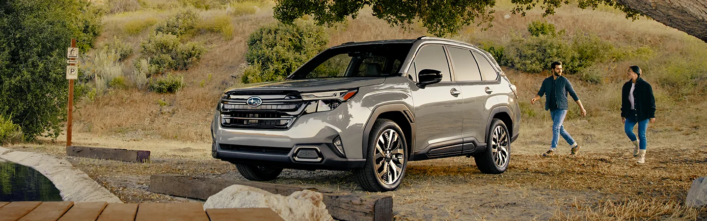 Front view of a gray 2026 Subaru Forester parked at a trail site