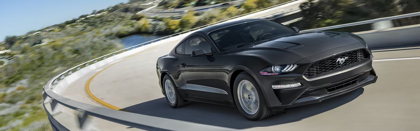 2023 Ford Mustang driving around a corner