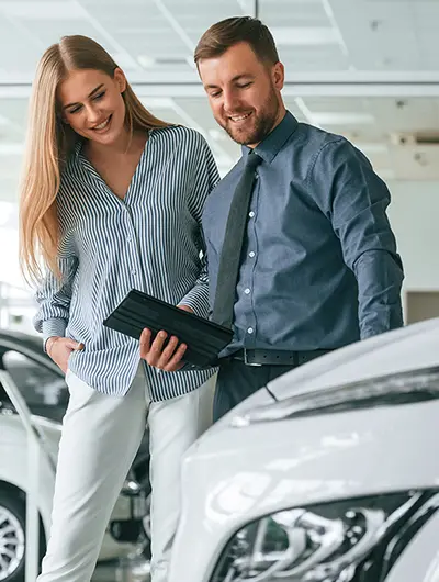 mechanic in the shop standing under a vehicle with his mechanis light