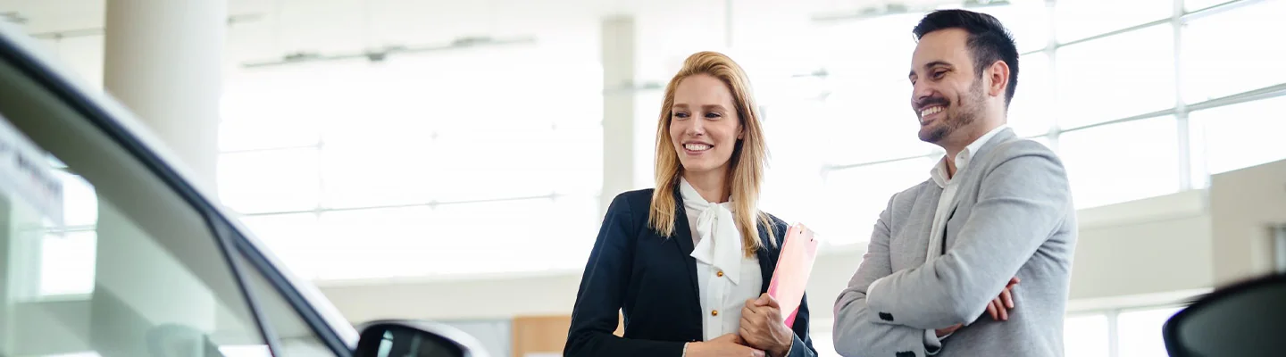 Sales person showing customer Used Cars for Sale