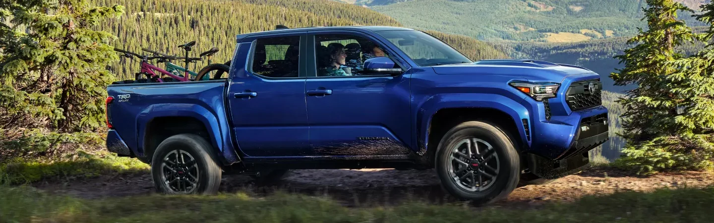 2024 Toyota Tacoma vs 2024 Toyota Tundra side front in blue