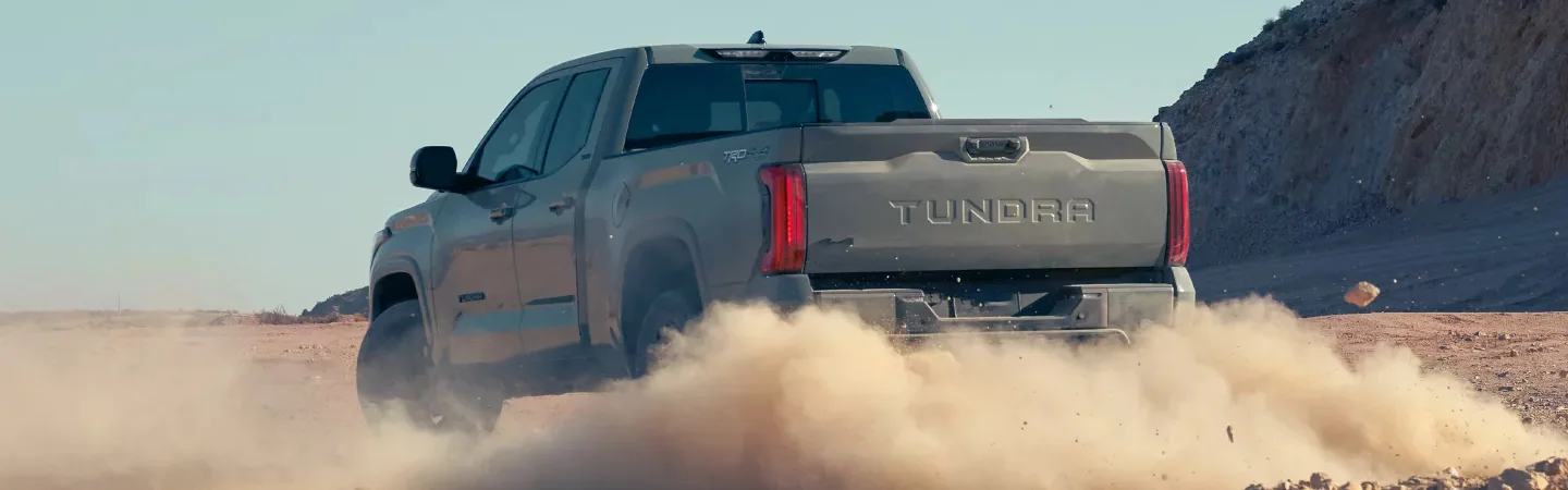 2024 Toyota Tacoma vs 2024 Toyota Tundra back side in brown 