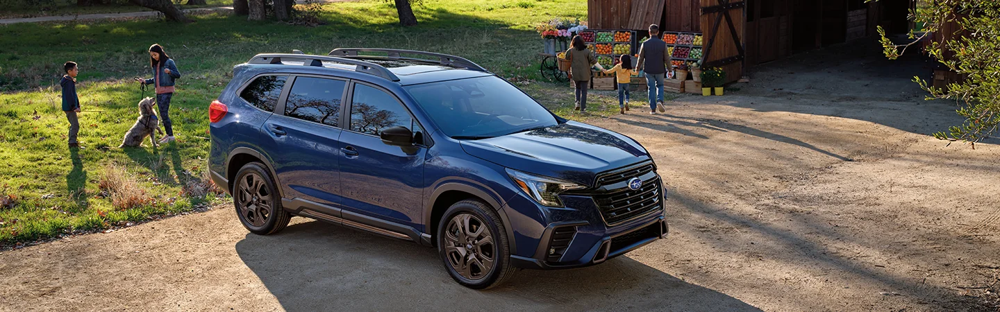 Front side view of a parked blue 2026 Subaru Ascent at a farmers market
