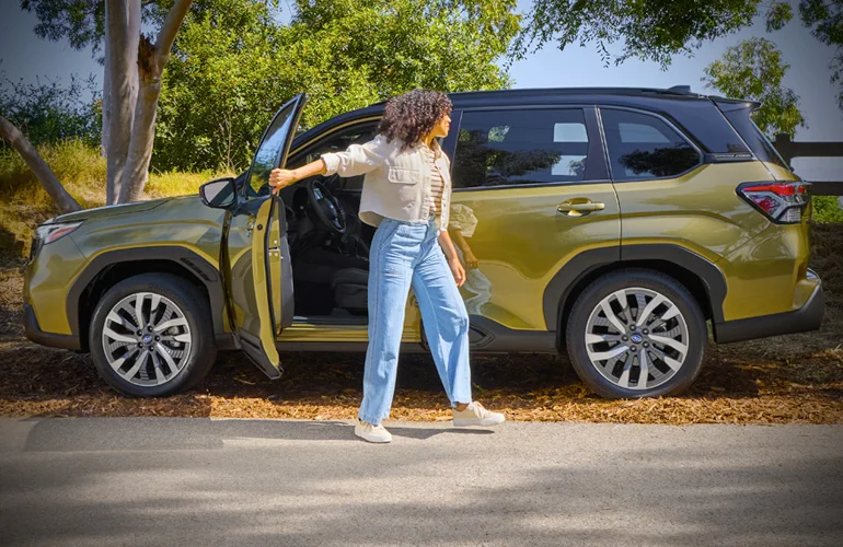 woman exiting her new Subaru