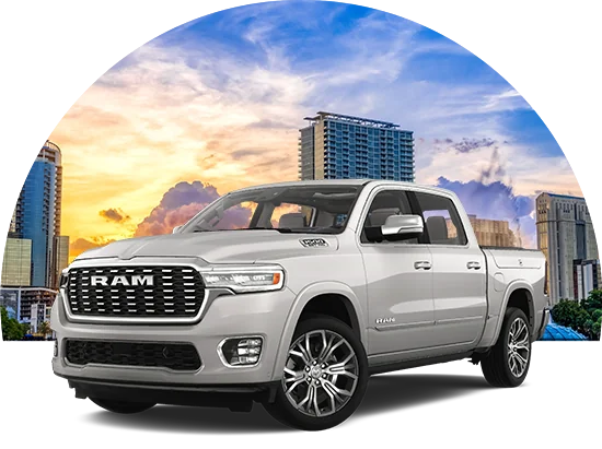 Gray RAM truck with a city in the background