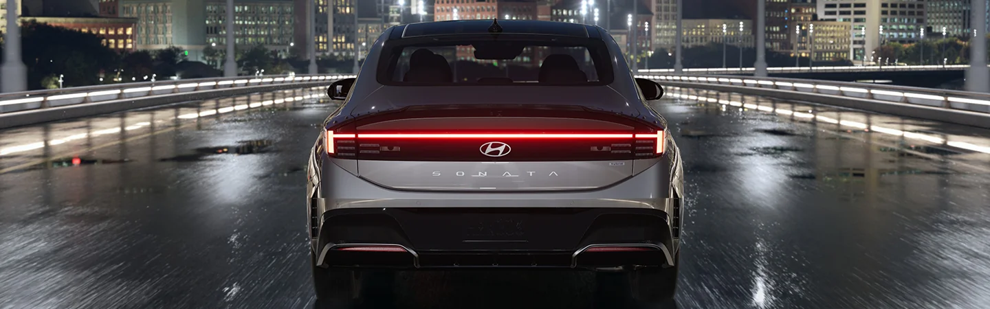 Back view of a parked 2025 Hyundai Sonata in a road
