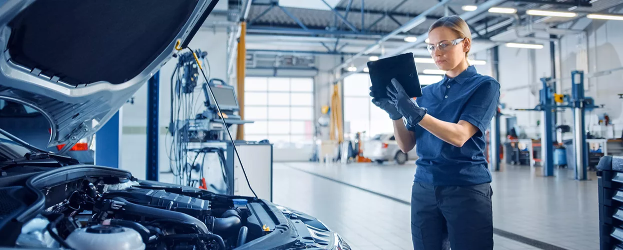 Mercedes-Benz Service mechanic taking a picture of the engine of a vehicle