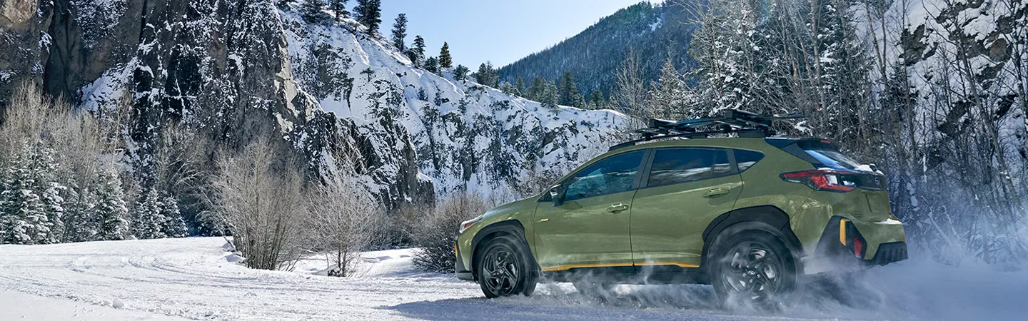 2026 Subaru Crosstrek driving on a snowy mountain road