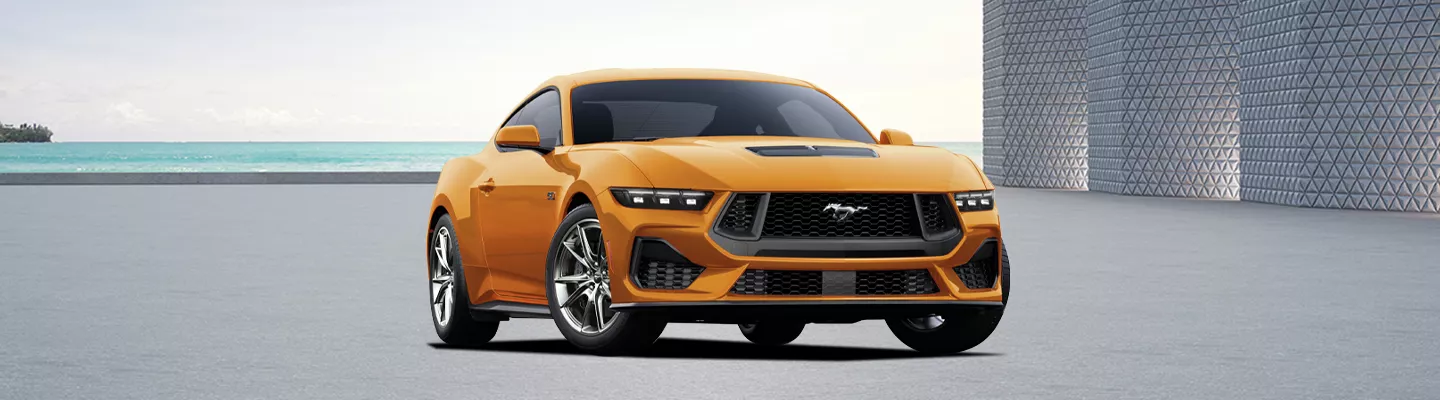2026 Ford Mustang parked in a parking lot in front of the ocean