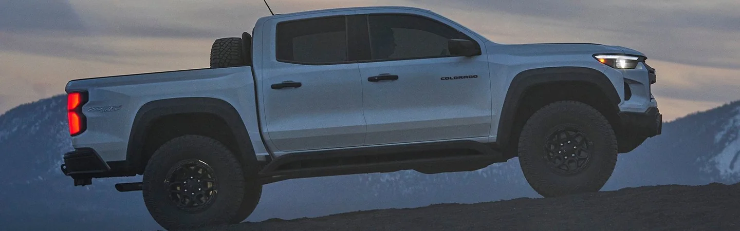 Side view of a parked 2024 Chevrolet Colorado in a sand hill