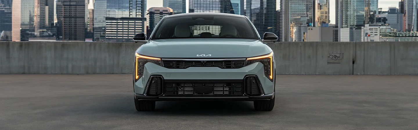 Front view of a 2025 Kia K4 in a parking a grage