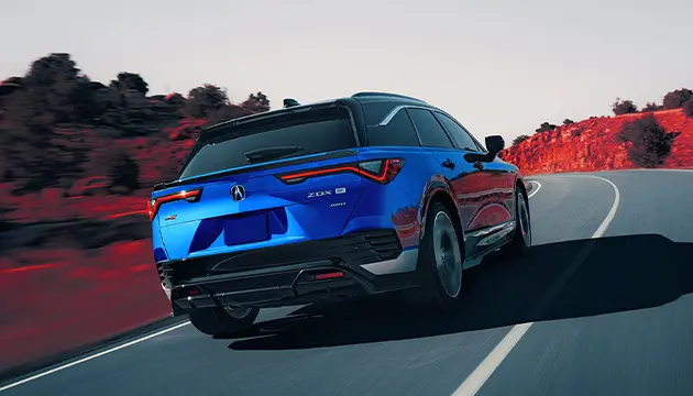 rear of new Acura on highway