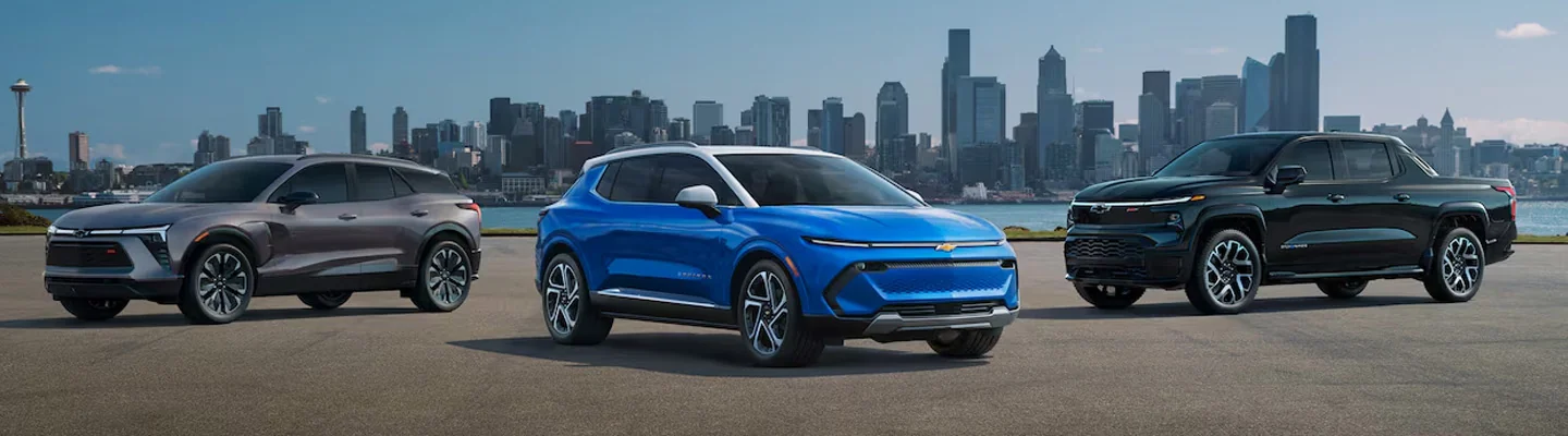 Three Electric Cars parked with a city in the background