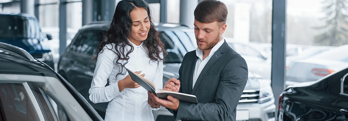 Sales person going over car information with a customer