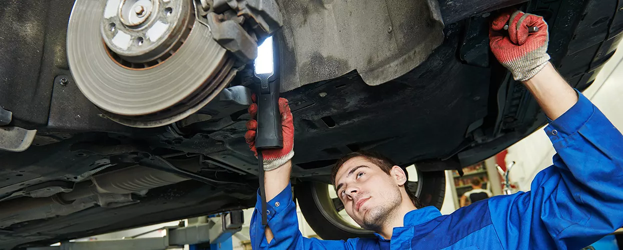 Service mechanic servicing a vehicle's brakes