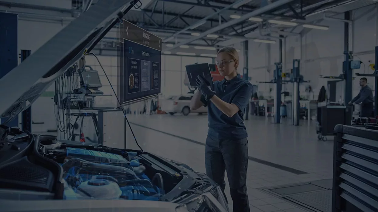 mechanic working on a vehicle in the garage using heads up and 3d display