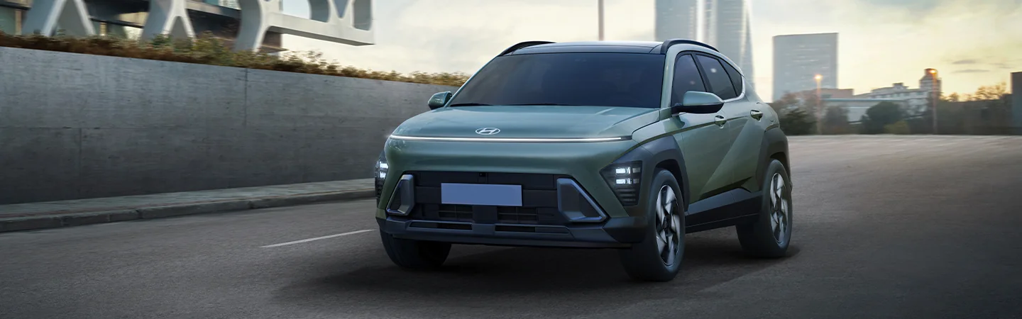 Green Hyundai Kona dring though the city