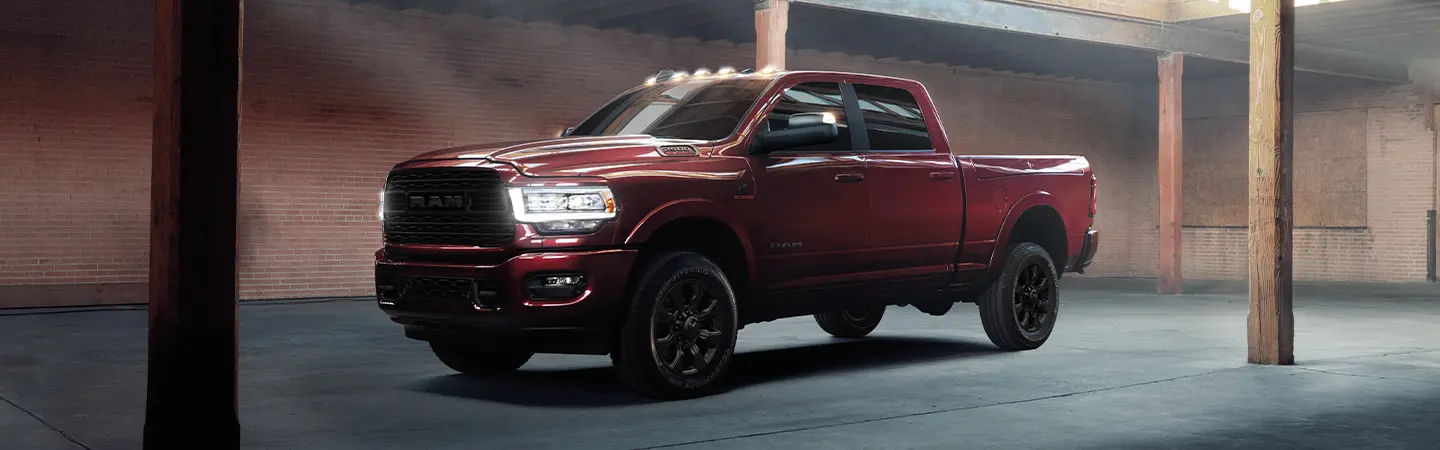 2024 RAM 2500 vs Ford Super Duty front side view red
