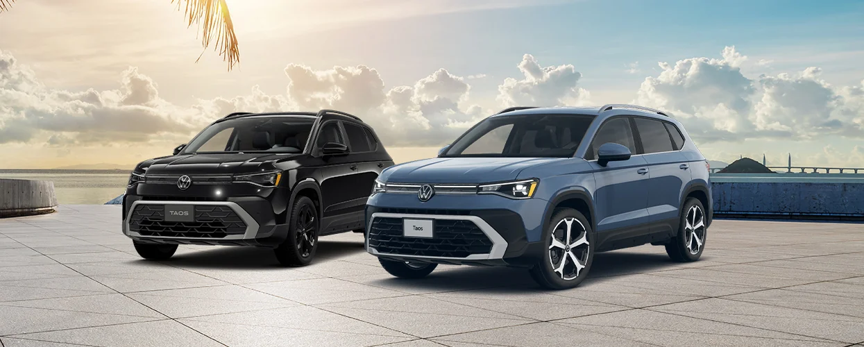 A black and blue 2026 Volkswagen Taos parked by a beach