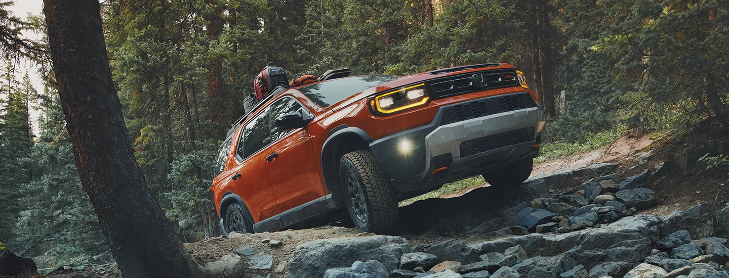 2026 Honda Passport driving on a mountain trail