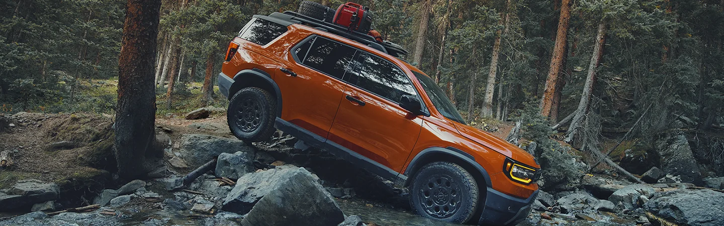 2026 Honda Passport driving over boulders