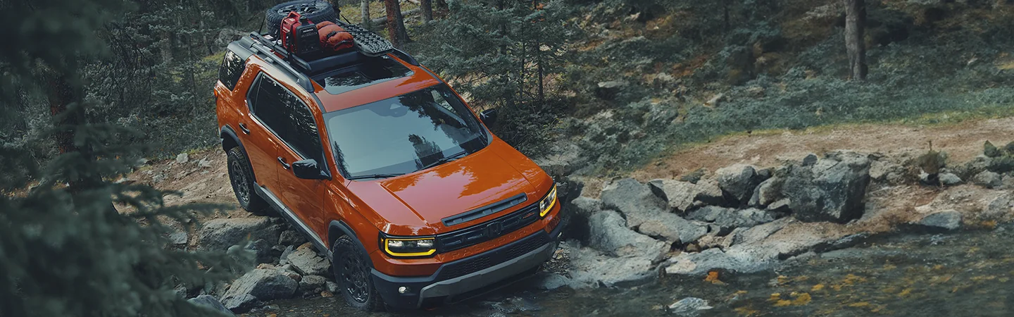 2026 Honda Passport driving over boulders