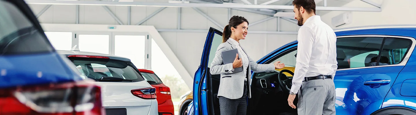 People talking in front of a Chevrolet vehicle