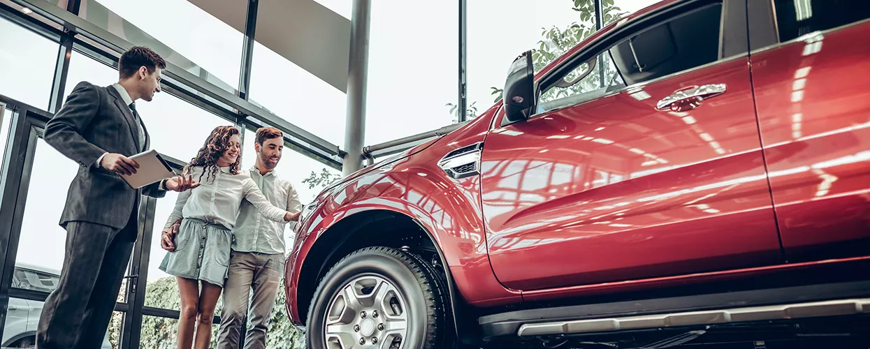 Couple looking at a new GMC vehicle at a dealership