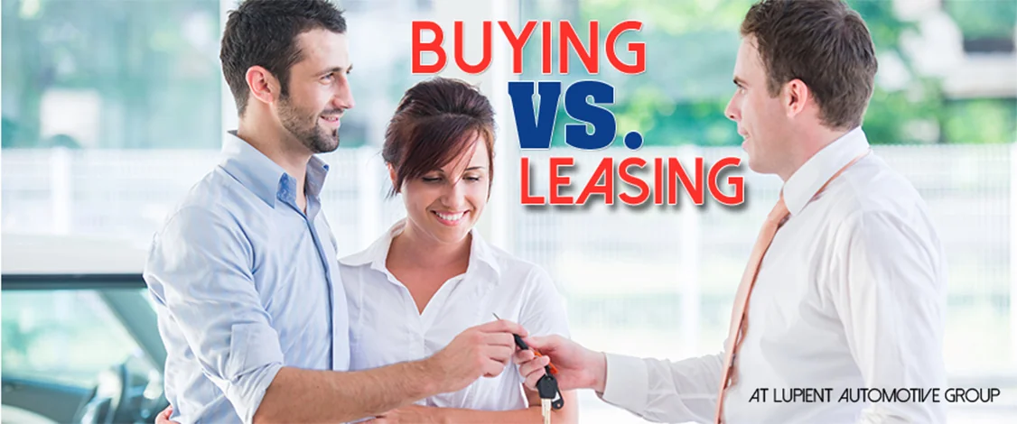 Buying vs Leasing image with couple being handed keys to new car from car salesperson