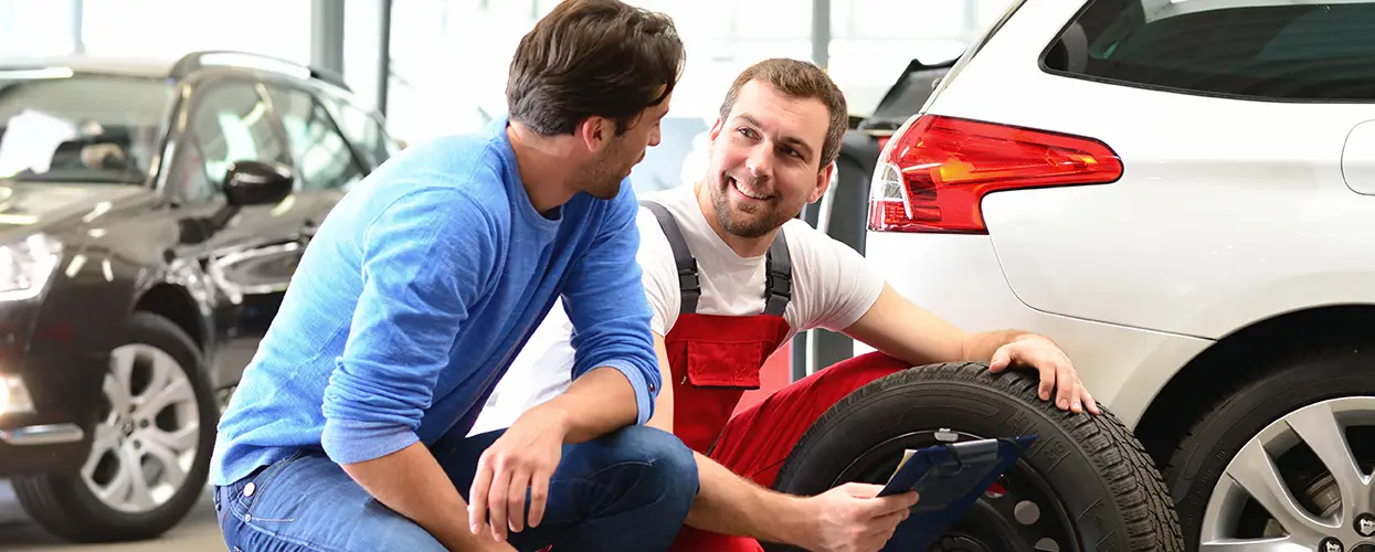 two men talking close together in garage