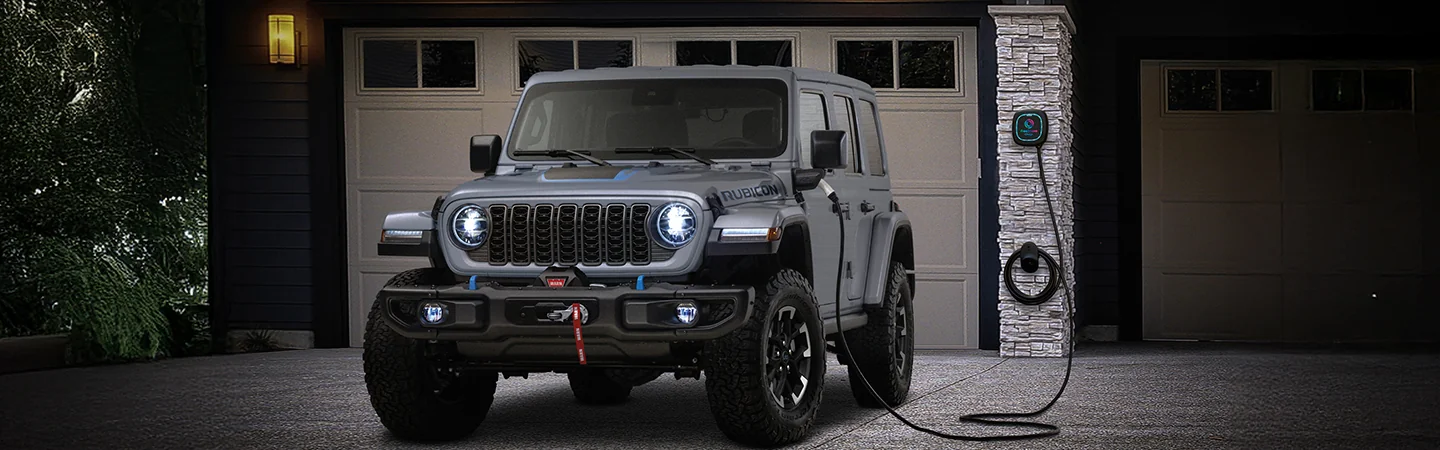 A 2025 Jeep Wrangler parked in a driveway charging