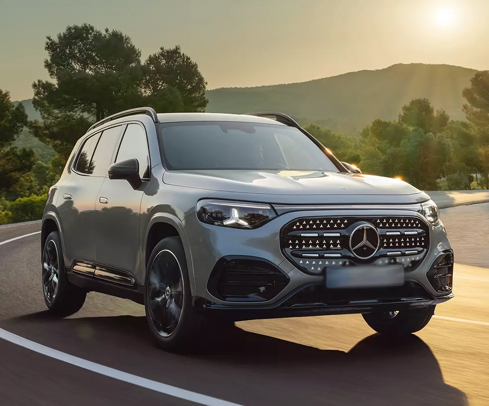 Front view of a gray 2026 Mercedes-Benz GLB driving on a road