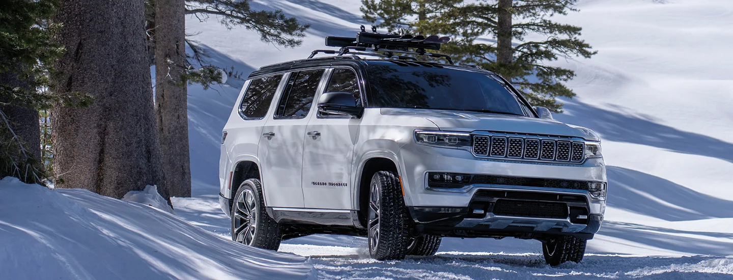 white 2025 Grand Wagoneer in snow