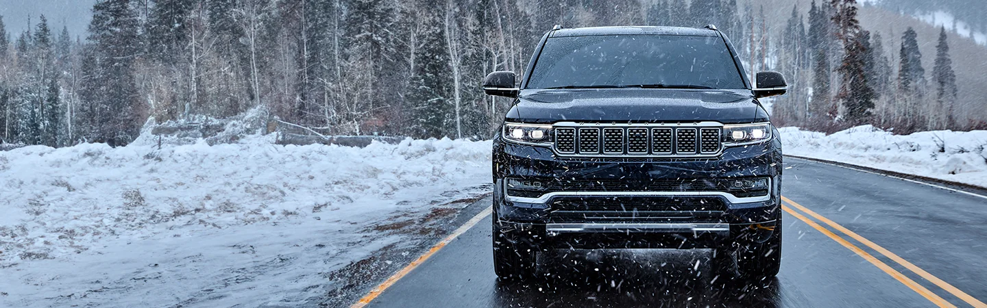 blue 2025 Grand Wagoneer in the snow