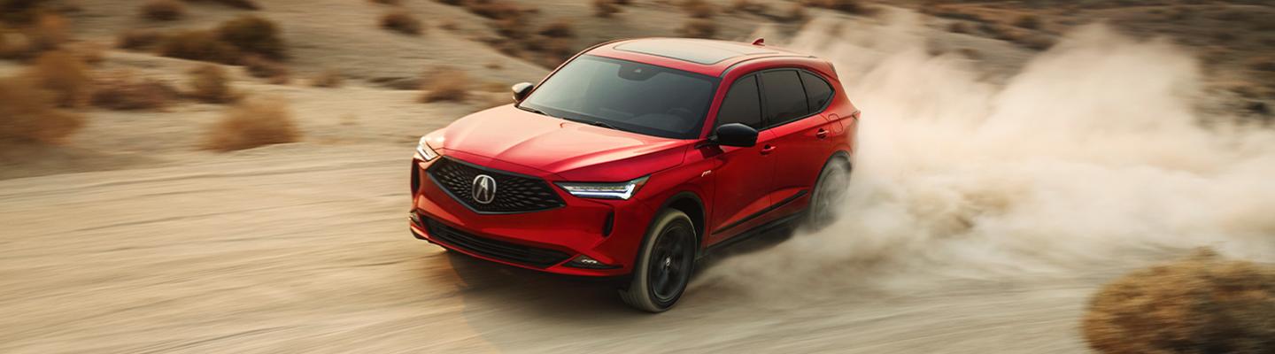 red acura suv in motion