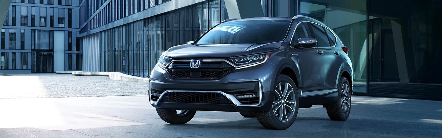 blue 2022 Honda CR-V Hybrid parked in front of modern building