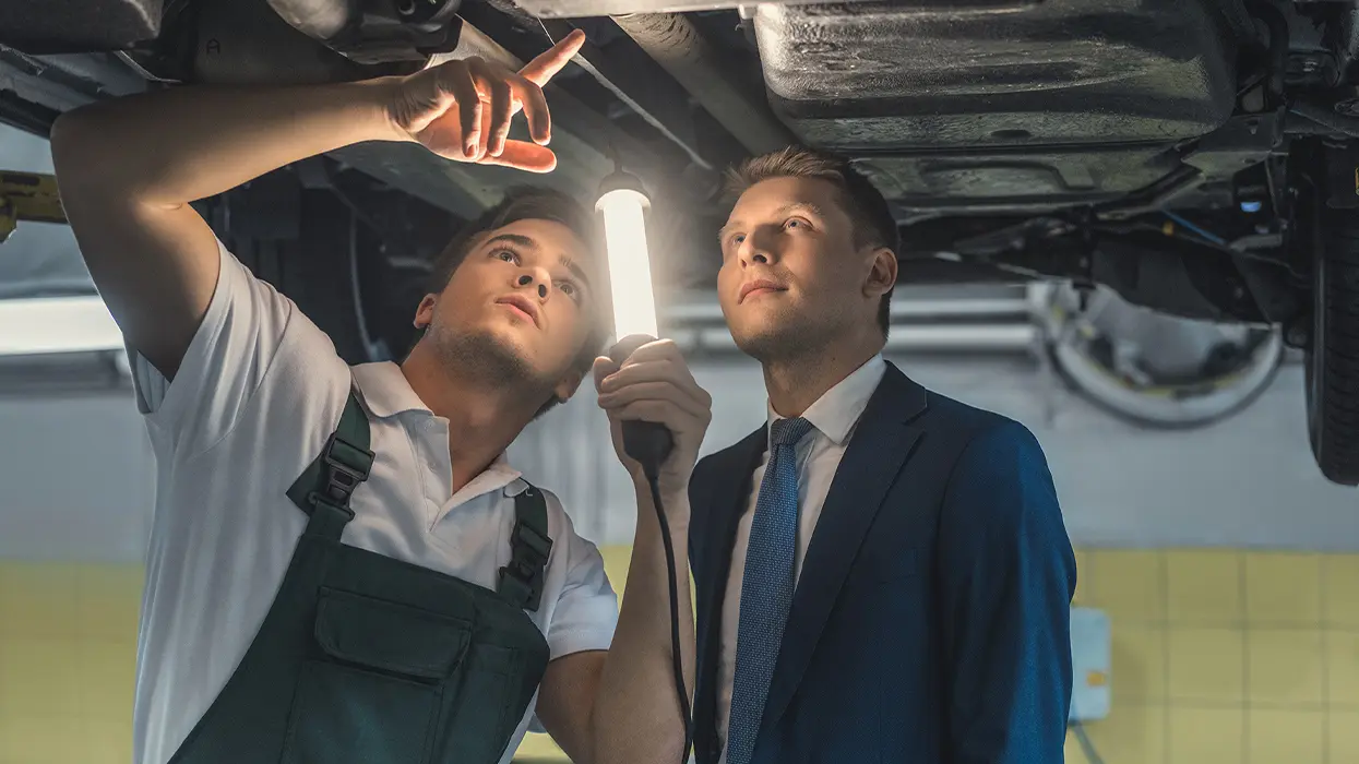 techs checking undercarriage together