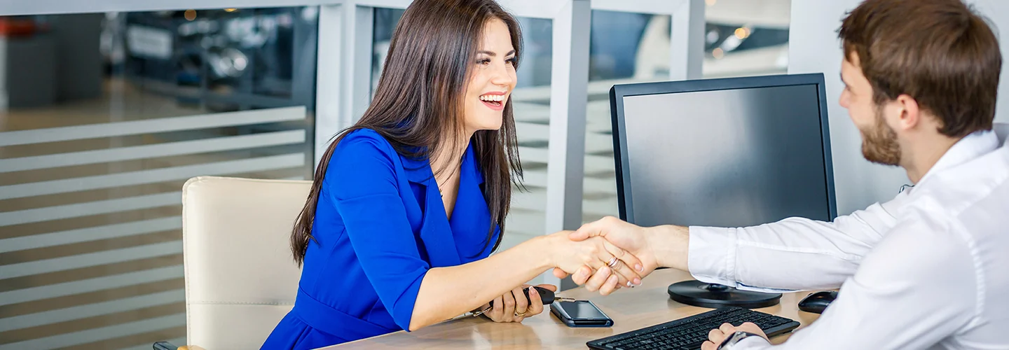 Customer and sales person shaking hands