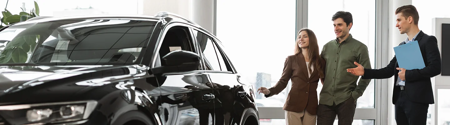 Car salesperson showing a vehicle to customers in Tyler, TX