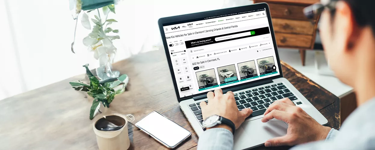 Person looking at dealership inventory on a laptop