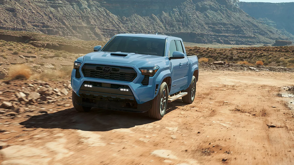 2026 Toyota Tacoma driving off-road on a dirt path