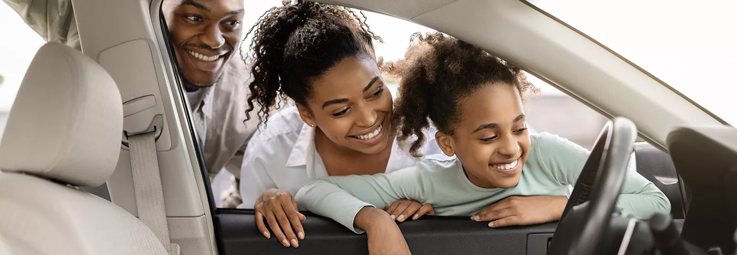 Family looking at a new Land Rover vehicle