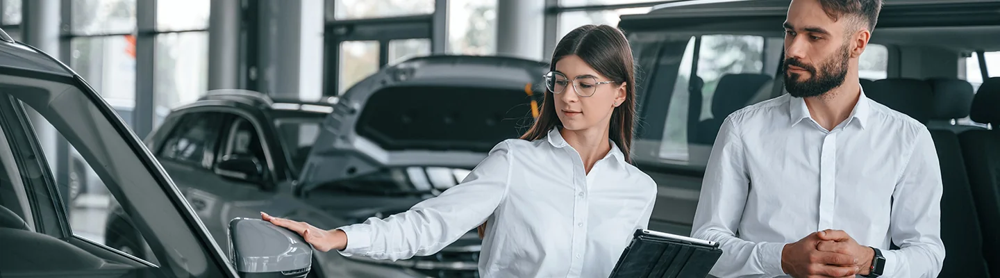 two technicians looking over a vehicle