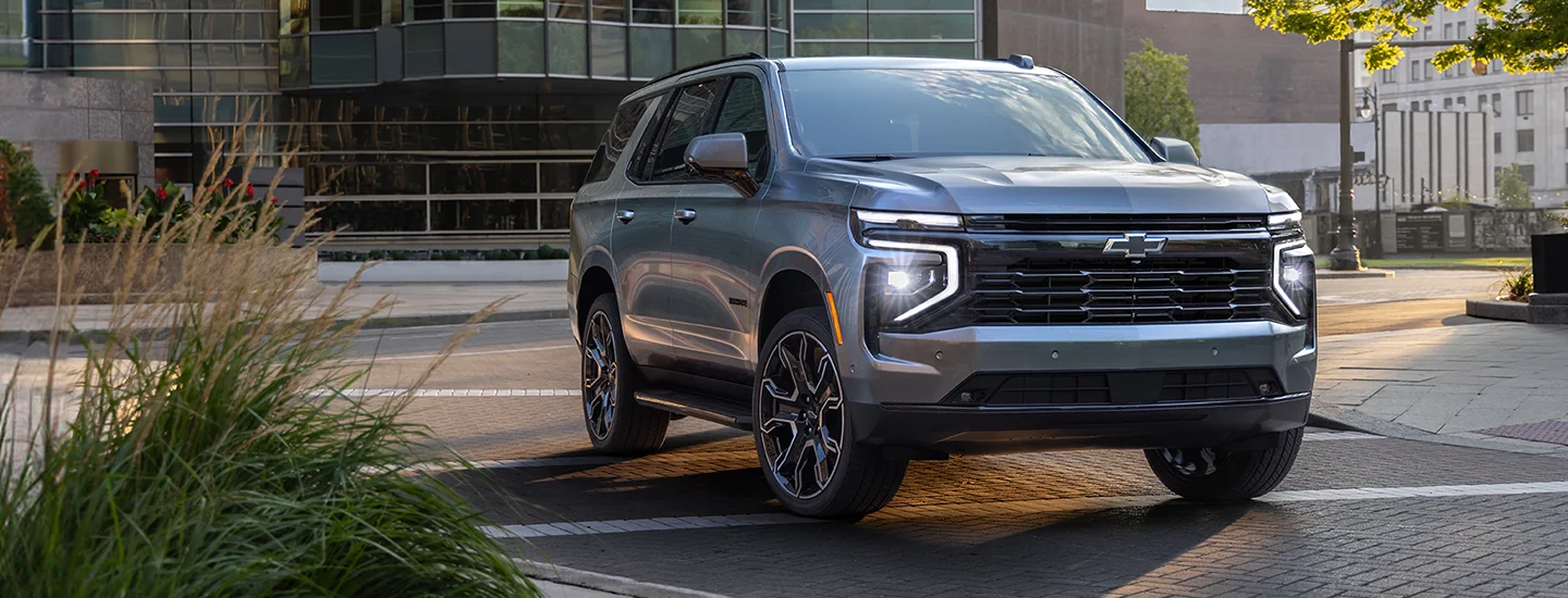 Gray 2025 Chevrolet Tahoe driving in the city