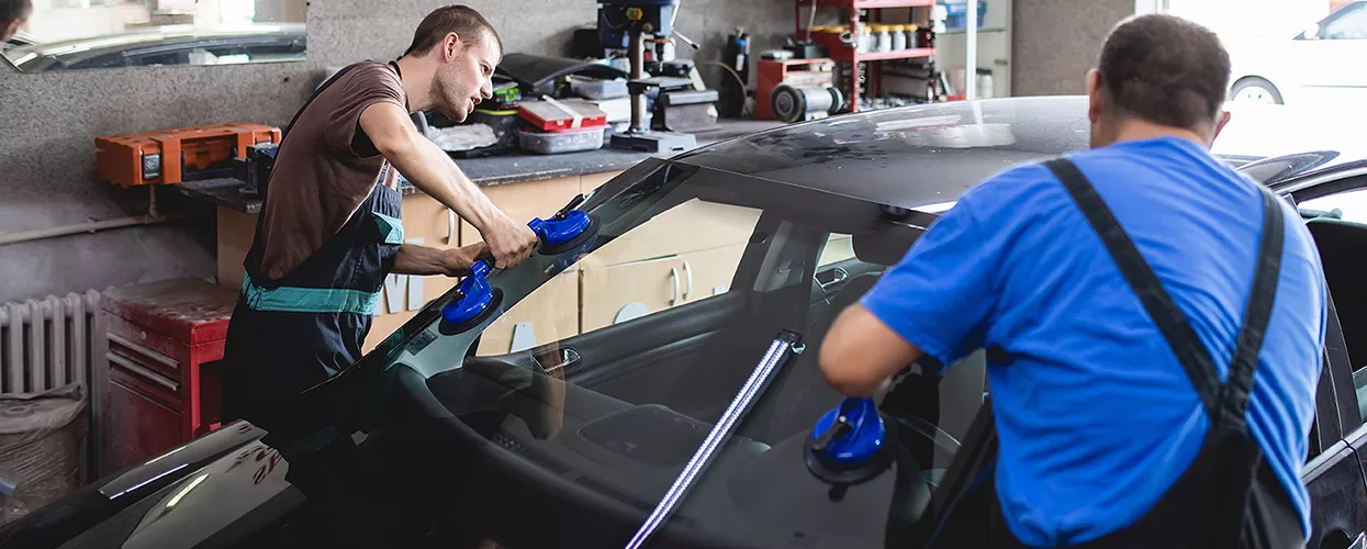 Service mechanic working on a vehicle in a service bay
